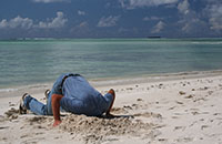 Man with head in sand because he won't deal with the problem of protecting his assets.